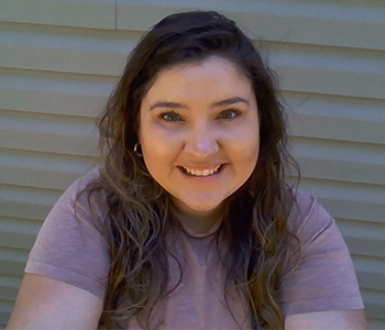 A woman in a purple shirt.
