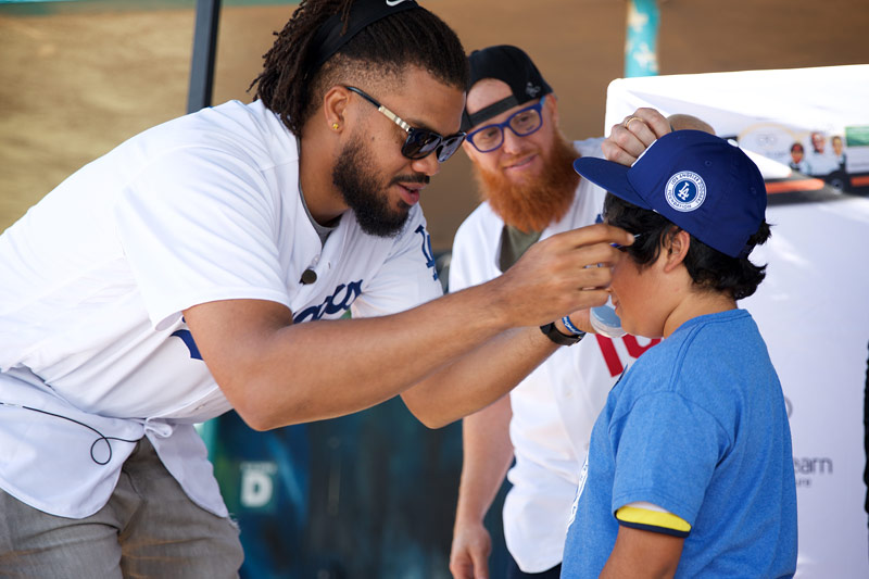 Los Angeles Dodgers Kenley Jansen and Justin Turner putting new glasses on a student, May 25, 2018