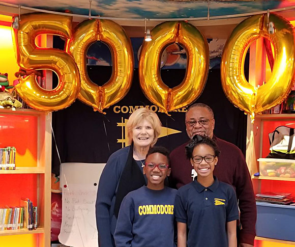 Ann Hollister and Wade Brown celebrate the 5,000th child to receive glasses from Vision To Learn, at Commodore John Rodgers Elementary/Middle School, December 10, 2018.