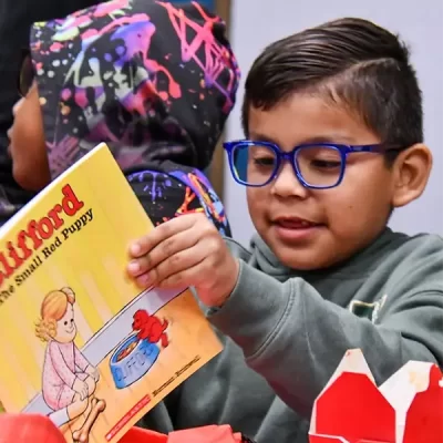 boy able to read book with new glasses