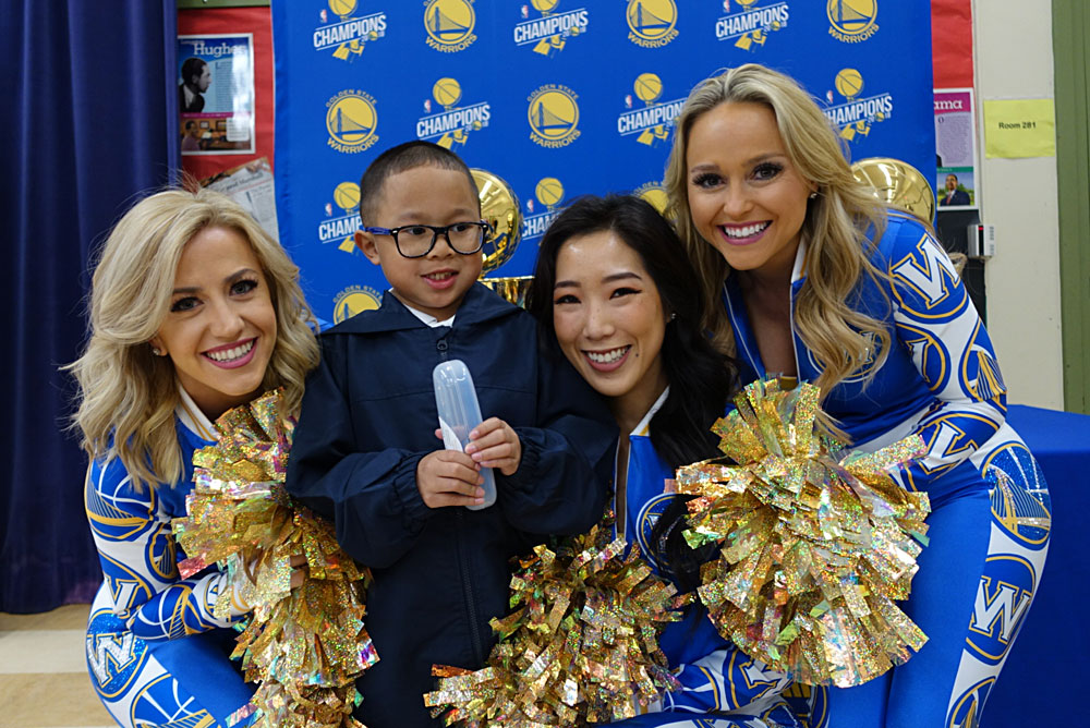 Smiles all around for this Garfield student and the Warriors Dance Team!