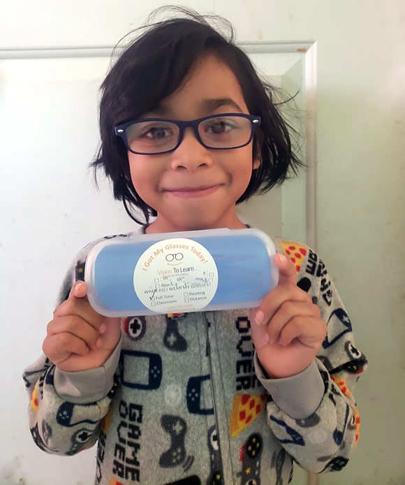 A student shows off their new glasses from home. During the pandemic, Vision To Learn delivered glasses to kids at their houses to help them with their virtual learning.