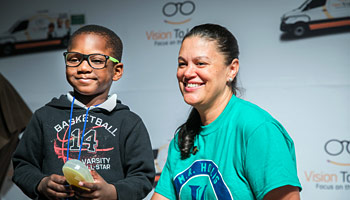 Atlanta Superindent with boy holding his new glasses